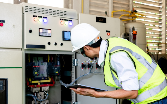 Field worker looking at machine